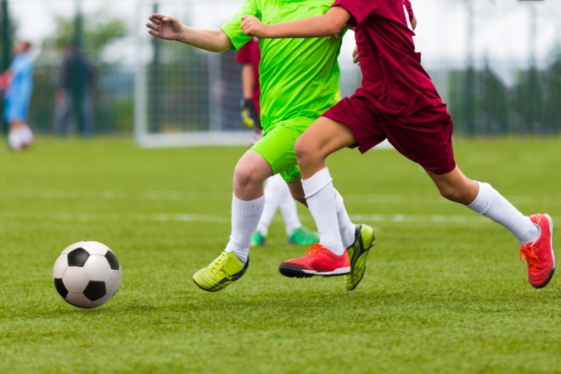 young-boys-playing-soccer-legs-closeup